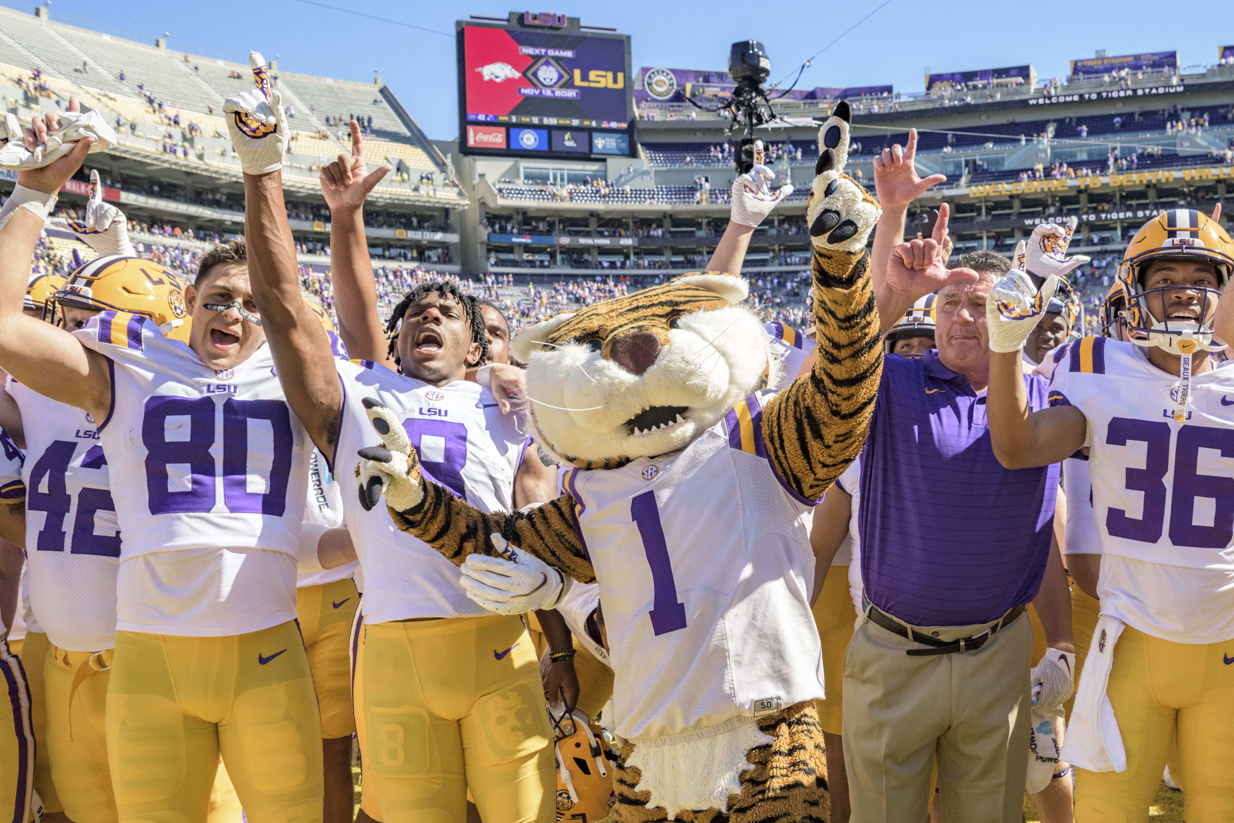 Former LSU head football coach, Ed Orgeron, right, talks to his