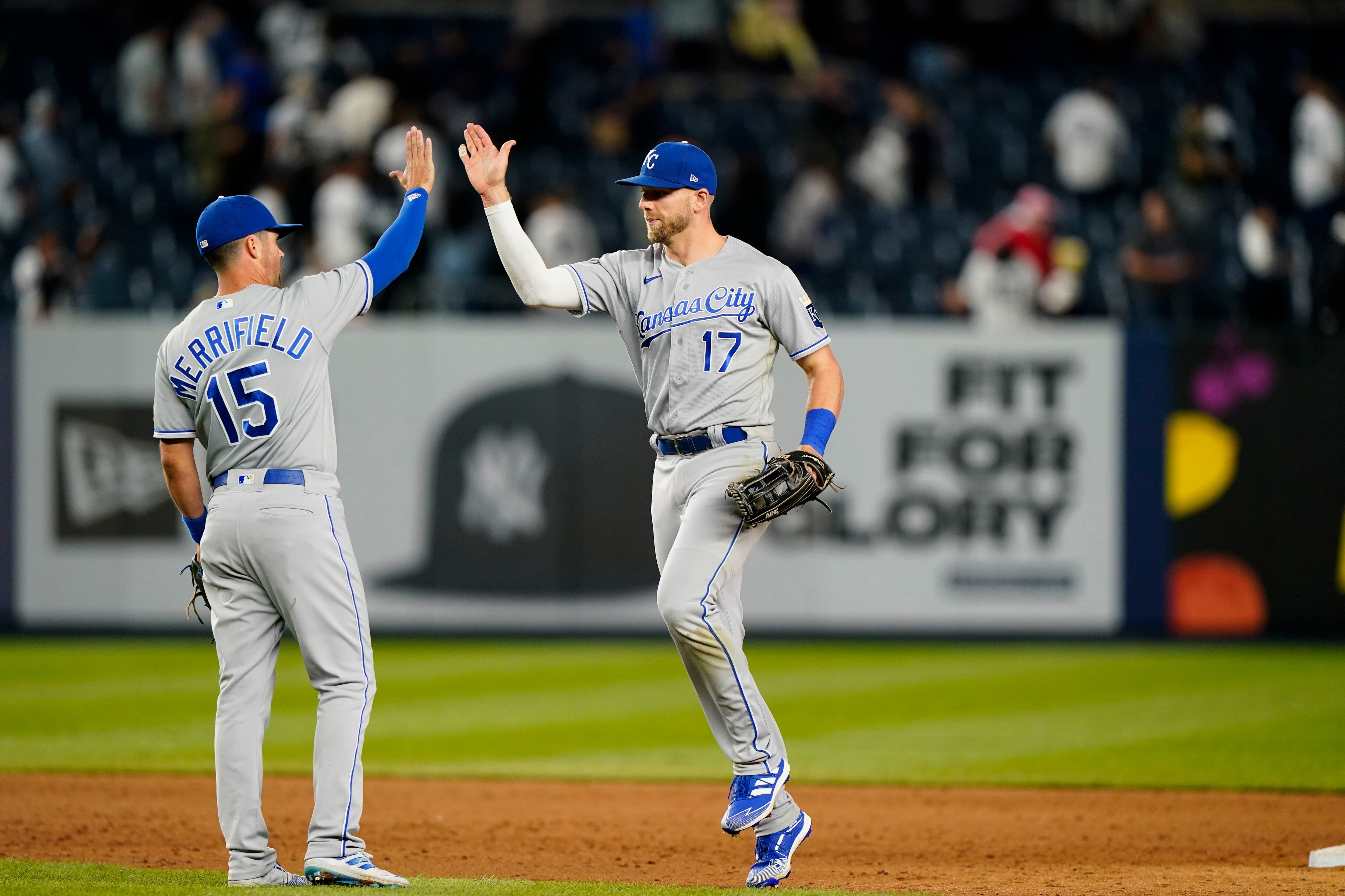 Kansas City Royals' Hunter Dozier, left, greets Whit Merrifield