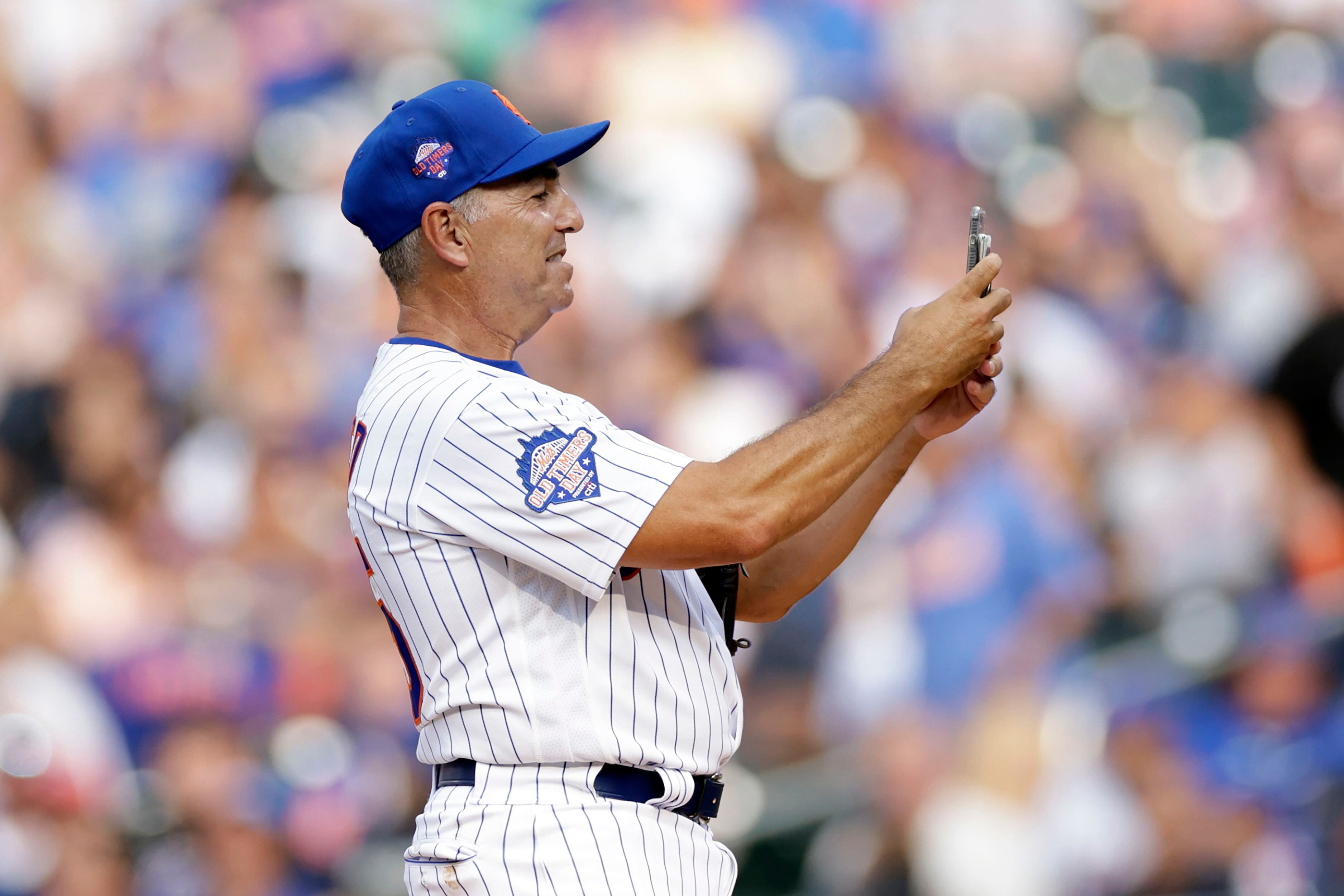 Former New York Mets pitcher Dwight Gooden throws during an Old-Timers'  game before a baseball game between the Colorado Rockies and the New York  Mets on Saturday, Aug. 27, 2022, in New