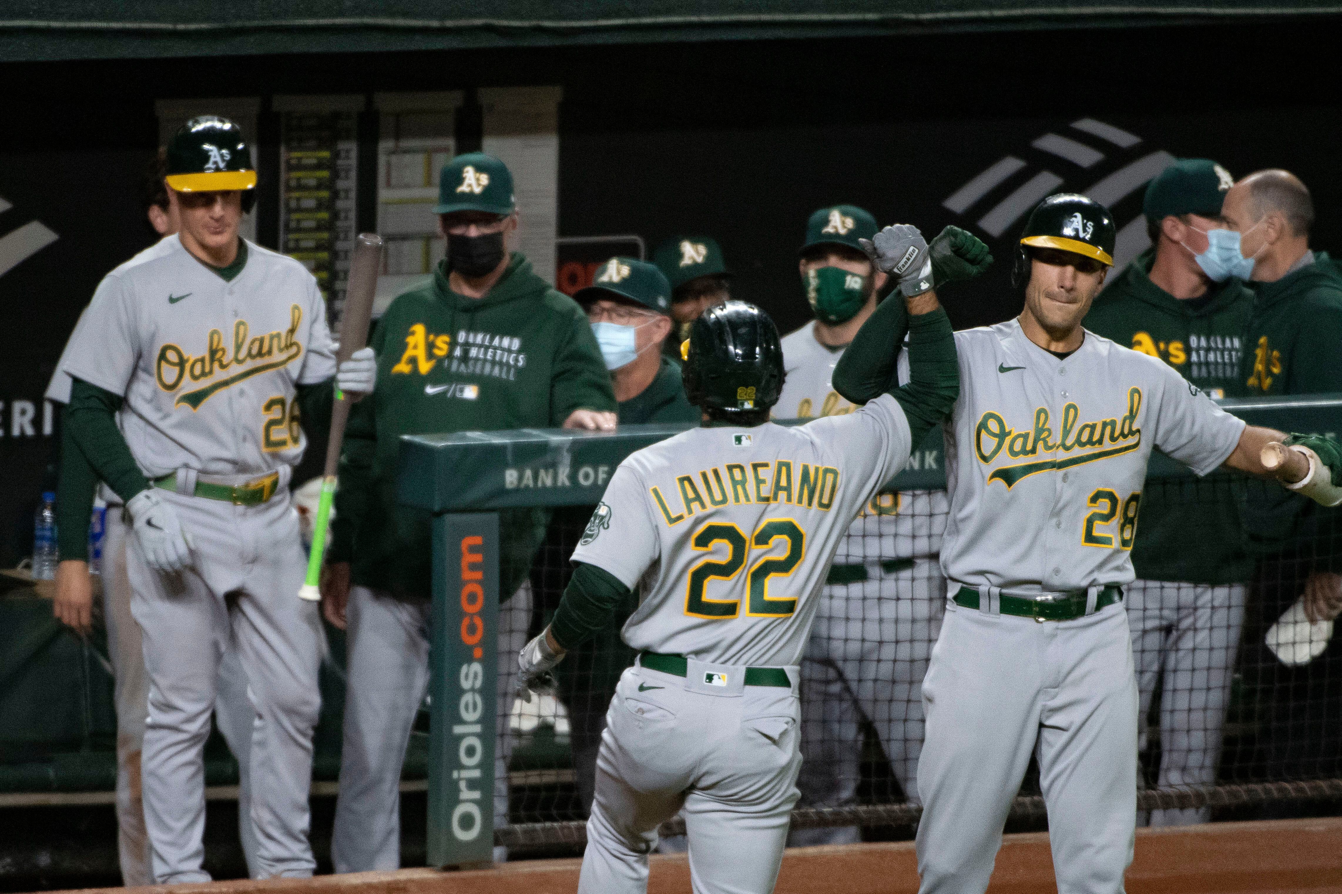 Oakland Athletics' Ramon Laureano, left, is tagged out by Houston