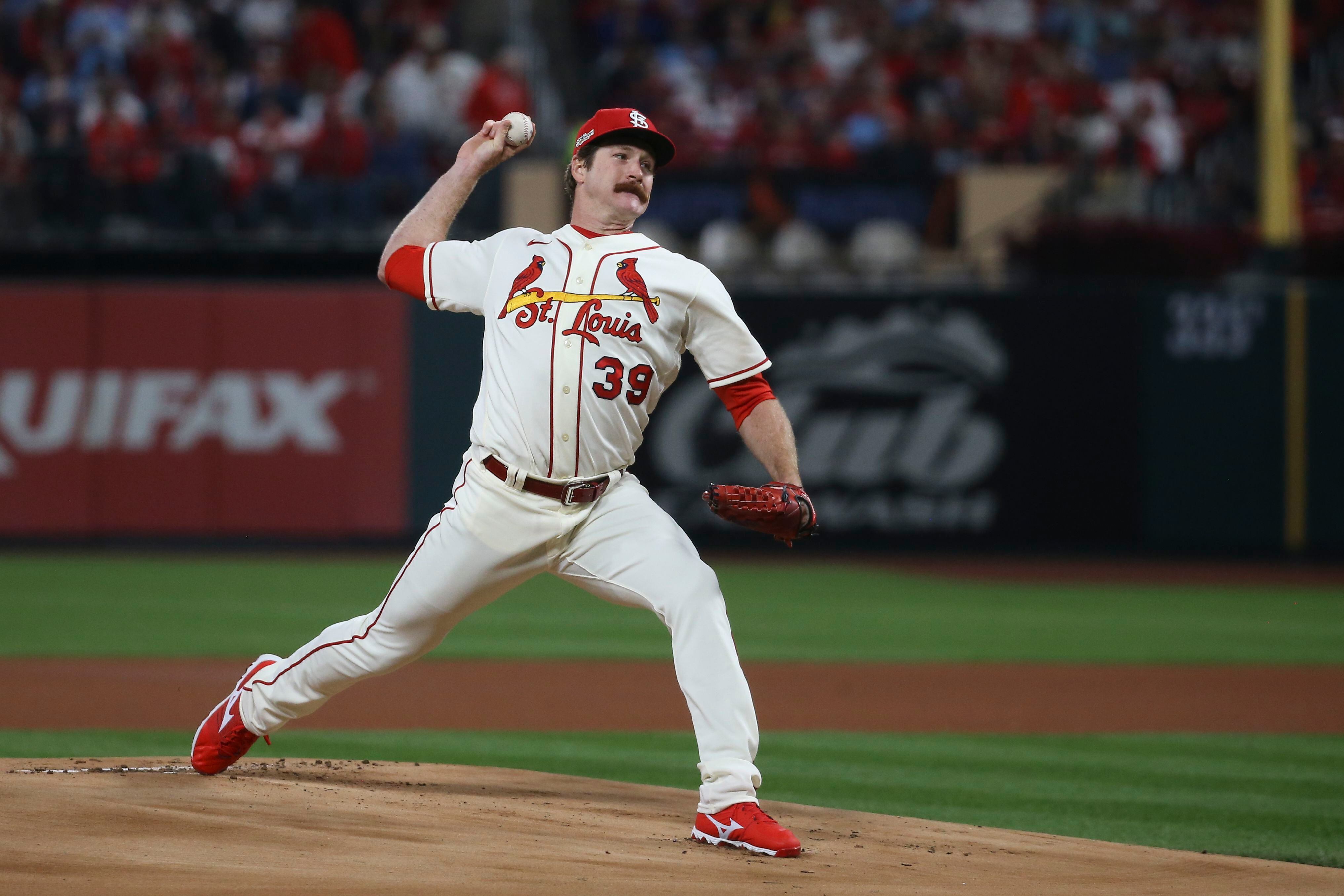 St. Louis Cardinals starter Miles Mikolas wipes his head and face