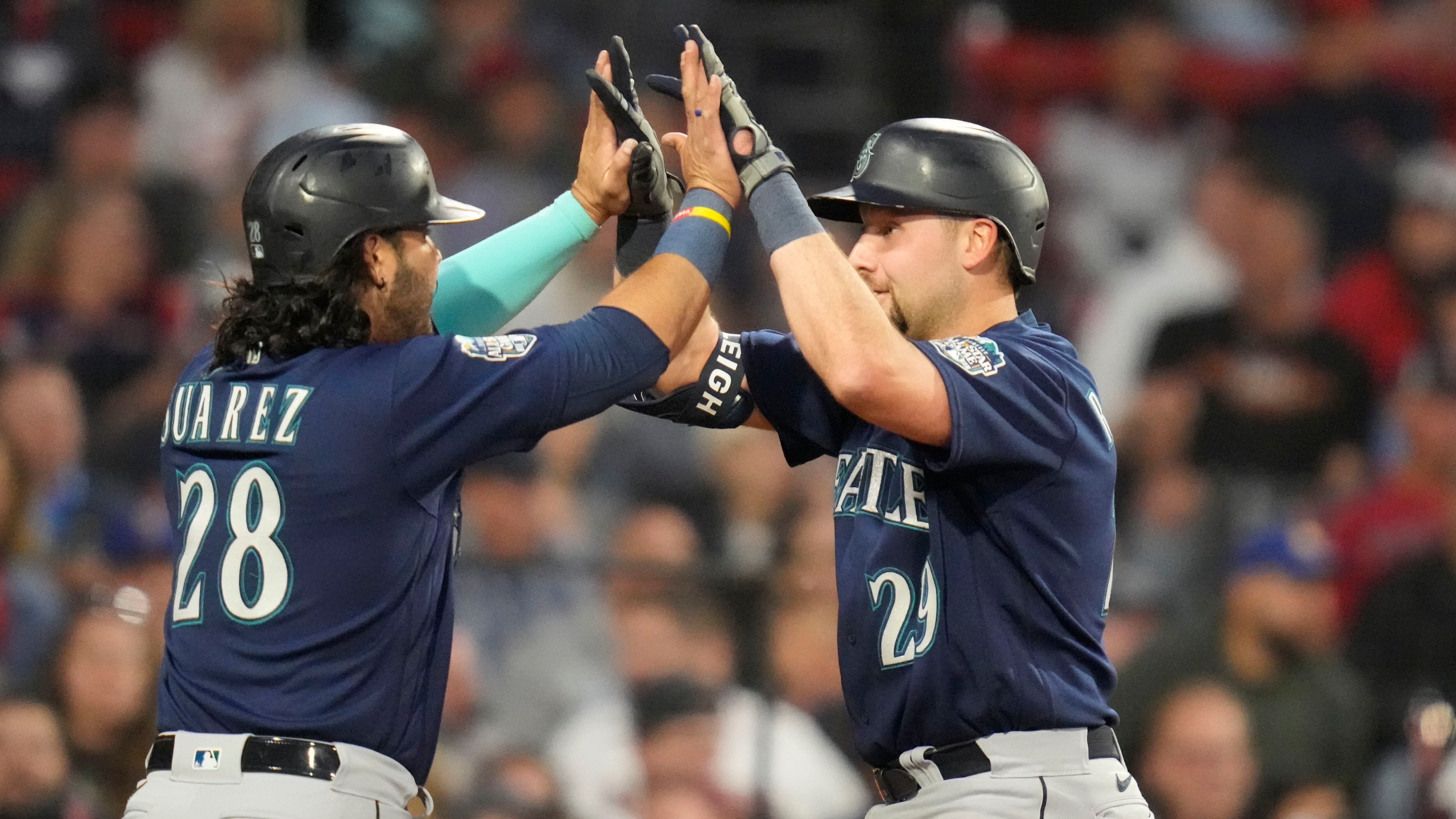 Seattle Mariners' Eugenio Suarez holds a trident while celebrating