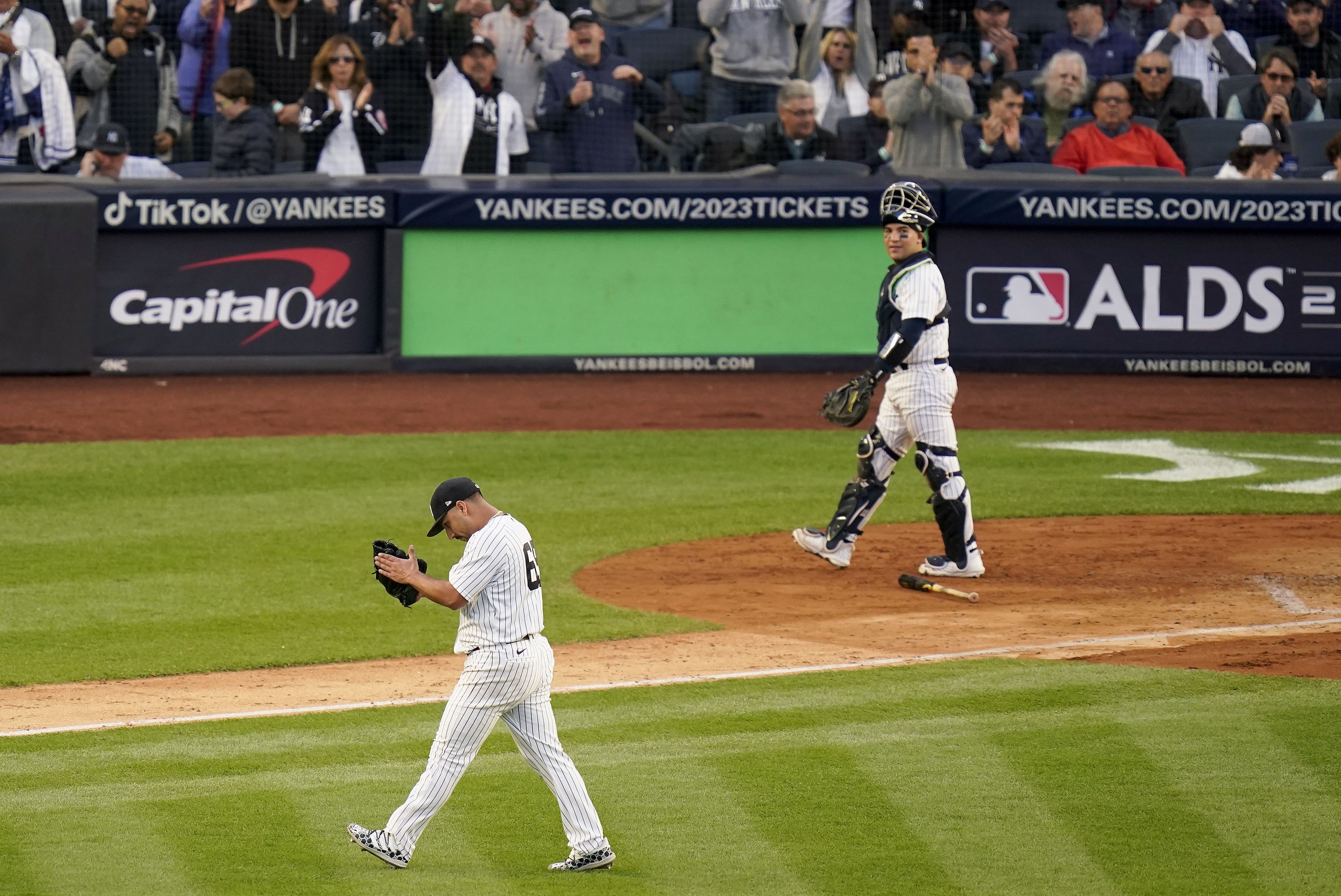 From left, New York Yankees' Anthony Rizzo, Aaron Judge and Giancarlo  Stanton celebrate in the locker room after the Yankees defeated Cleveland  Guardians in Game 5 of an American League Division baseball