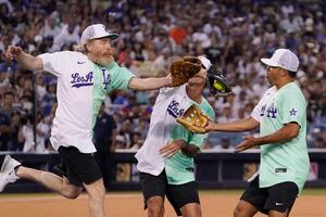 Rapper and singer Bad Bunny runs in the outfield during the MLB All Star  Celebrity Softball game, Saturday, July 16, 2022, in Los Angeles. (AP  Photo/Mark J. Terrill)